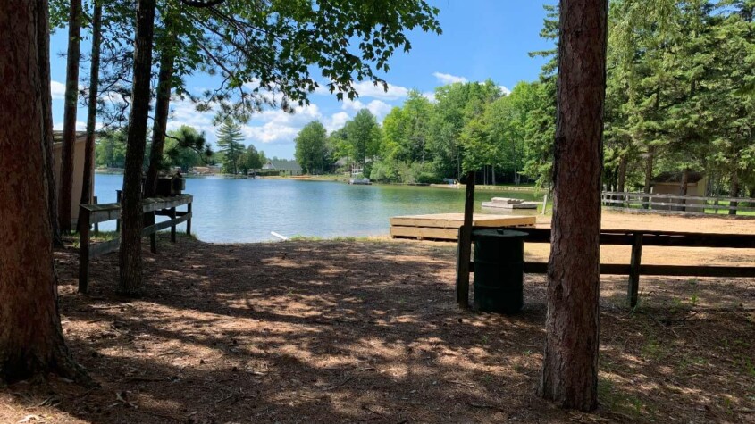A sunny campground with a lake in the background. This could represent Camp Therapyology, the summer camp for teens in West Bloomfield, MI. Contact us to learn how summer programs for teens can help your teen!