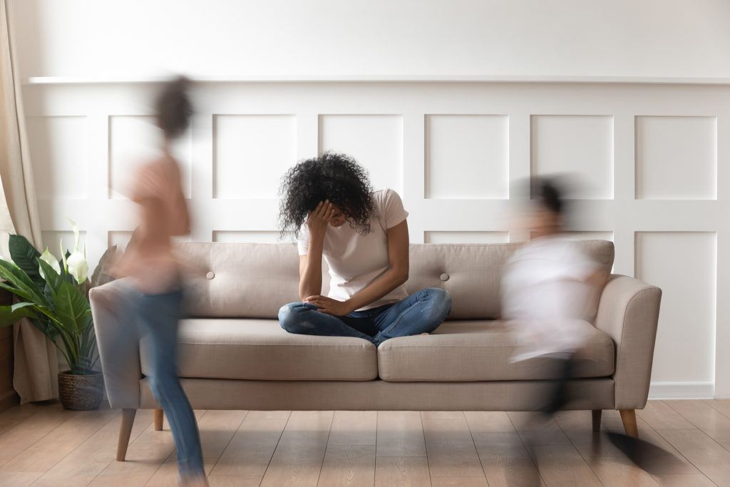 A tired mother hangs her head as her children rush around the room. Parent coaching in West Bloomfield, MI can offer support. Learn more about parent support groups in San Francisco, CA today.