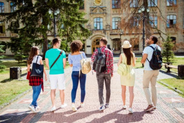 A group of college students walk in a link towards campus. Life transitions counseling in Michigan can offer support with new beginnings. Learn more about transitions counseling in Michigan or search "life transitions counseling in West Bloomfield, MI" today.: 