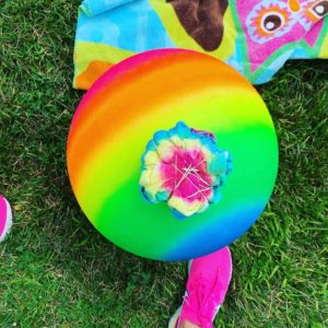 A close up of a rainbow ball in the grass for Therapyology. We offer group therapy in West Bloomfield, MI. You can join from the comfort of home with online therapy. Learn more about group thearpy in San Francisco, CA and other services today! 48322 | 94118 | 48324