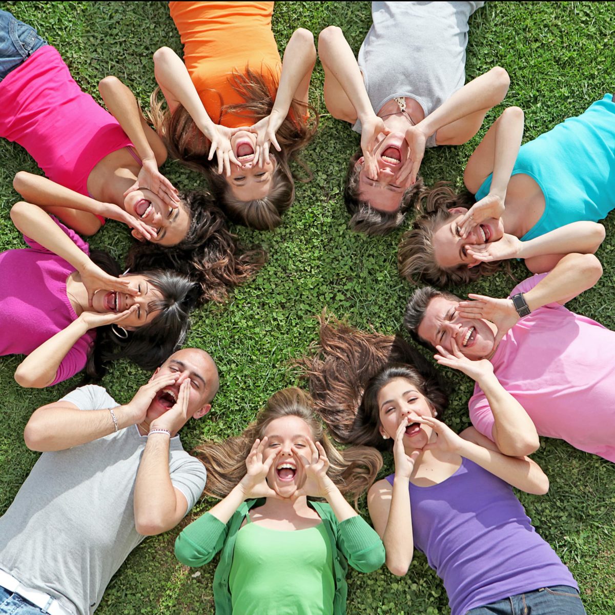 A group of young adults lay on the grass in a circle as they cheer. This could represent the support group therapy in West Bloomfield, MI can provide. Contact a child therapist for divorce in West Bloomfield, MI to learn more about our services today! 48322 | 94118