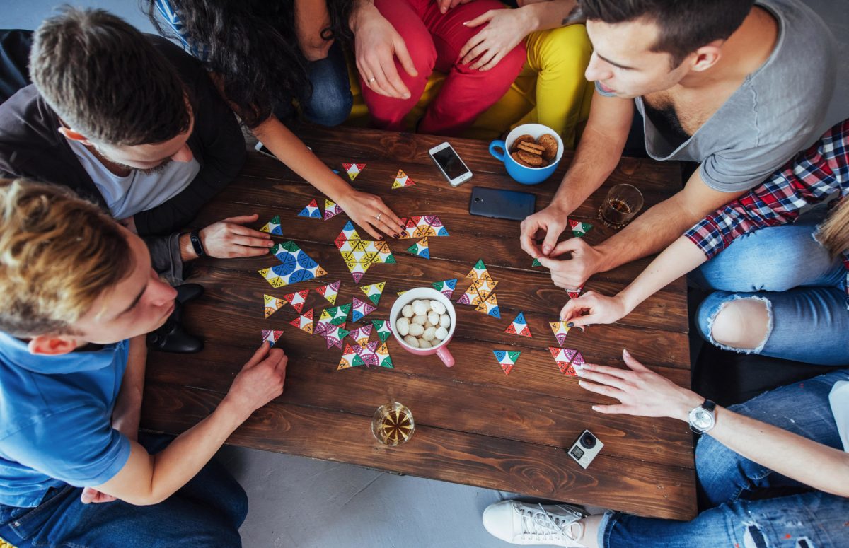 A top down view of teens sitting around a table as they play a boardgame. This could represent the support that group therapy in West Bloomfield, MI can offer. Contact us to today to learn more about group therapy for teens in San Francisco, CA and the other services including parent support groups! | 48332 | 94118