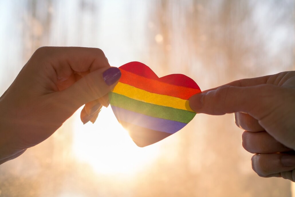 Two hands hold either side of a rainbow heart as the sun shines behind it. Therapyology acknowledges the struggles of individuals identifying as LGBTQ+. They offer LGBTQ therapy in west bloomfield, mi, gender therapy in west bloomfield, mi, and more. Contact us today to get in touch with an lgbt ally in west bloomfield, mi
