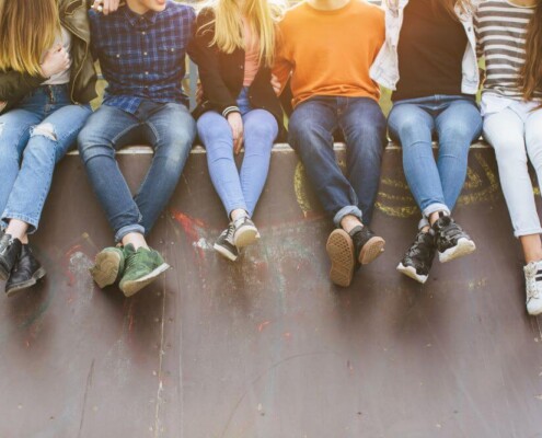 Group of teens sitting on a wall