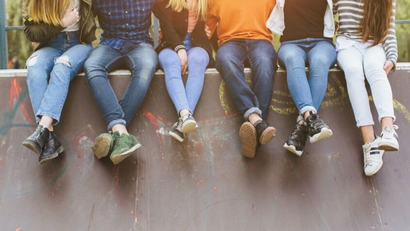 Group of teens sitting on a wall
