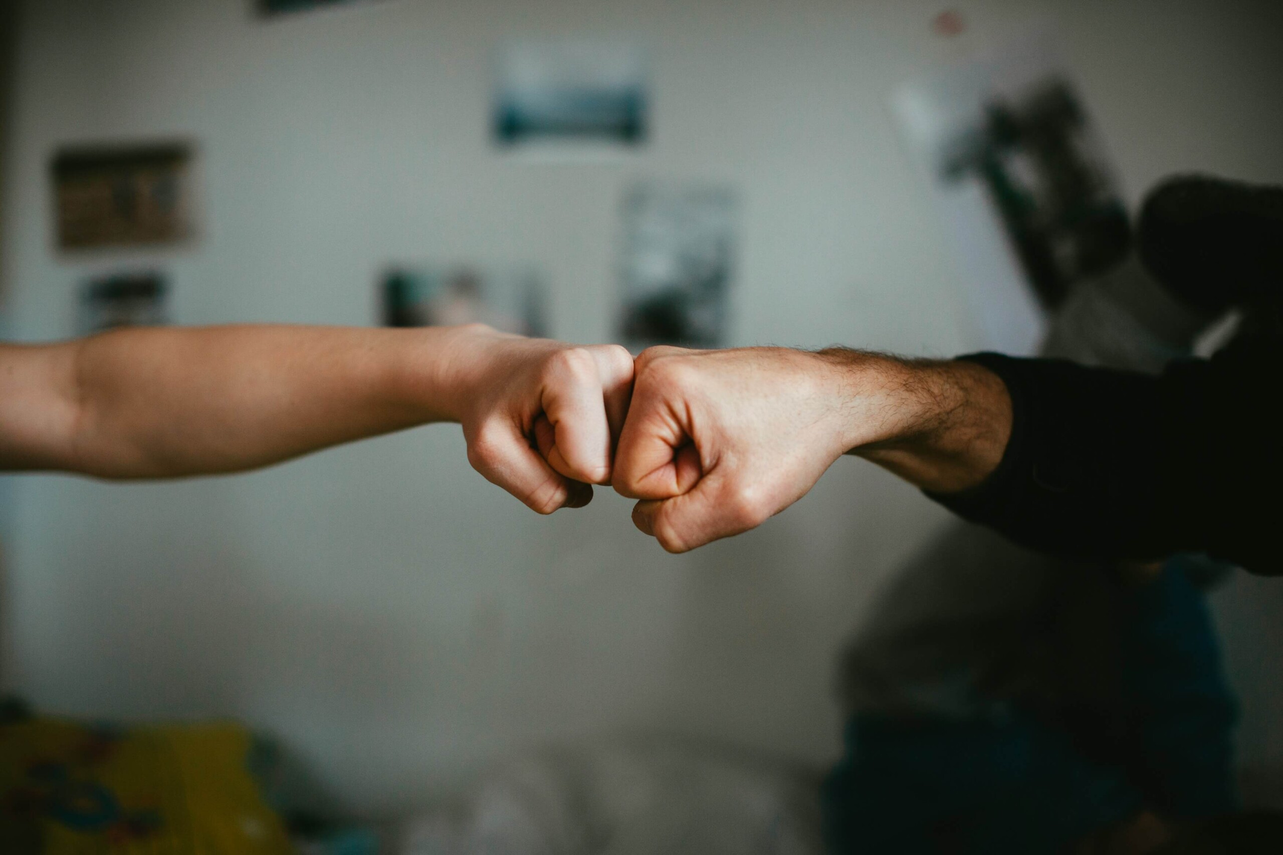 Image of two people making fists and putting them together. Find support in fostering healthier connections with your friends with the help of a skilled young adult therapist in West Bloomfield, MI.