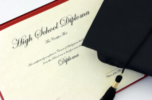 A high school diploma and graduation cap. Representing the major change that teen counseling and young adult therapy can help with. Get your child support with life transitions counseling in Michigan.